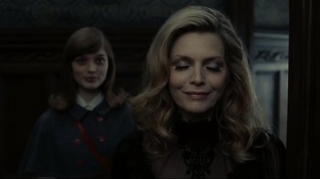 Movie still from “Dark Shadows” (2012), directed by Tim Burton – A woman in a black dress and a little girl in a red dress; Close Up shot, Over the shoulder angle