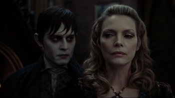 Movie still from “Dark Shadows” (2012), directed by Tim Burton – A man and a woman standing next to each other; Close Up shot, Over the shoulder angle