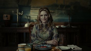 Movie still from “Dark Shadows” (2012), directed by Tim Burton – A woman sitting at a table with a plate of food in front of her; Medium shot, Low angle