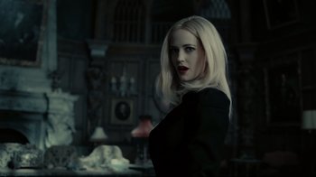 Movie still from “Dark Shadows” (2012), directed by Tim Burton – A woman with blonde hair wearing a black shirt; Medium shot, Low angle