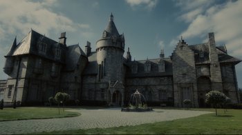 Movie still from “Dark Shadows” (2012), directed by Tim Burton – A large castle like building with a fountain in front of it; Extreme Wide shot, Low angle