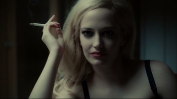 Movie still from “Dark Shadows” (2012), directed by Tim Burton – A woman holding a cigarette in her right hand; Close Up shot, Over the shoulder angle