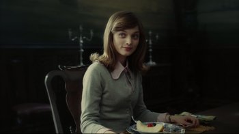 Movie still from “Dark Shadows” (2012), directed by Tim Burton – A woman sitting at a table with a plate of food; Medium shot, Over the shoulder angle
