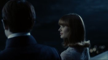 Movie still from “Dark Shadows” (2012), directed by Tim Burton – A woman in a white dress and a man in a blue suit stand next to each other in the dark; Close Up shot, Over the shoulder angle