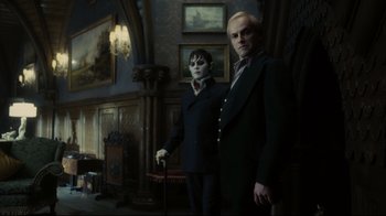 Movie still from “Dark Shadows” (2012), directed by Tim Burton – Two men in suits stand next to each other in an ornate room; Medium shot, Low angle