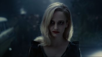 Movie still from “Dark Shadows” (2012), directed by Tim Burton – A woman with blonde hair wearing a black top; Close Up shot, Over the shoulder angle