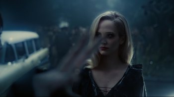 Movie still from “Dark Shadows” (2012), directed by Tim Burton – A woman with blonde hair is standing in the dark; Close Up shot, Over the shoulder angle