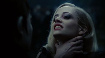 Movie still from “Dark Shadows” (2012), directed by Tim Burton – A beautiful blonde haired woman with dark make up; Close Up shot, Over the shoulder angle