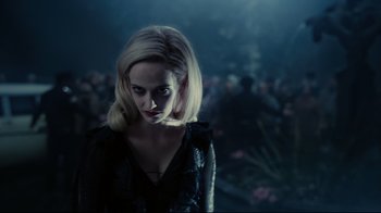 Movie still from “Dark Shadows” (2012), directed by Tim Burton – A woman with blonde hair is standing in the dark; Close Up shot, Over the shoulder angle