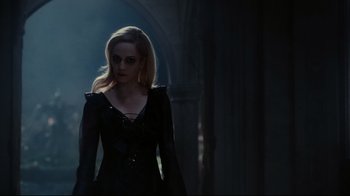 Movie still from “Dark Shadows” (2012), directed by Tim Burton – A woman in a black dress standing in a dark room; Medium shot, Over the shoulder angle