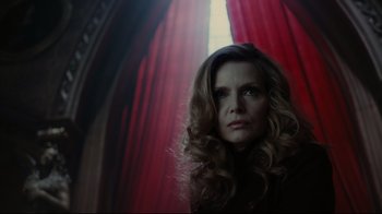 Movie still from “Dark Shadows” (2012), directed by Tim Burton – A woman standing in front of a red curtain; Close Up shot, Low angle