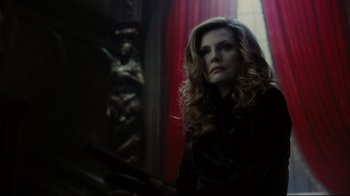 Movie still from “Dark Shadows” (2012), directed by Tim Burton – A woman with long blonde curly hair is looking at the camera; Medium shot, Low angle
