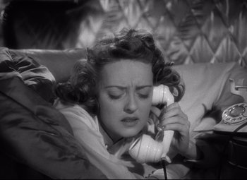 Movie still from “Dark Victory” (1939), directed by Edmund Goulding – A black and white photo of a woman talking on a phone; Close Up shot, Overhead angle