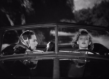 Movie still from “Dark Victory” (1939), directed by Edmund Goulding – Two women in the back seat of a vintage car; Medium shot, Low angle