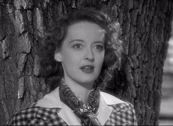Movie still from “Dark Victory” (1939), directed by Edmund Goulding – A black and white photo of a woman in front of a tree; Close Up shot, Low angle