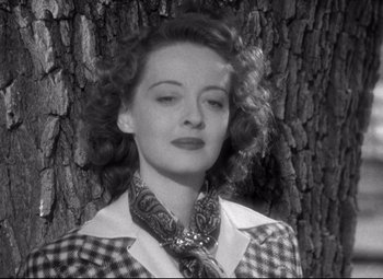 Movie still from “Dark Victory” (1939), directed by Edmund Goulding – An old black and white photo of a woman in front of a tree; Close Up shot, Low angle
