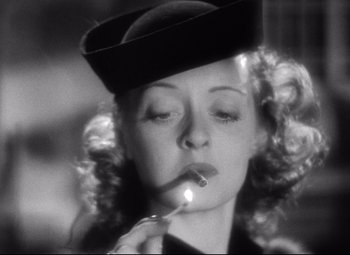 Movie still from “Dark Victory” (1939), directed by Edmund Goulding – A black and white photo of a woman smoking a cigarette; Close Up shot, Low angle