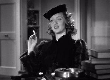 Movie still from “Dark Victory” (1939), directed by Edmund Goulding – A black and white photo of a woman smoking a cigarette; Close Up shot, Low angle