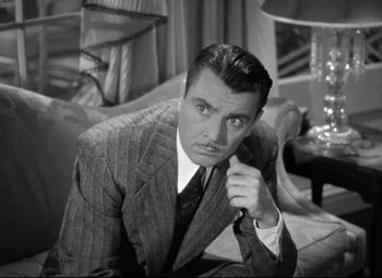 Movie still from “Dark Victory” (1939), directed by Edmund Goulding – A black and white photo of a man in a suit and tie; Close Up shot, High angle