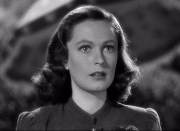 Movie still from “Dark Victory” (1939), directed by Edmund Goulding – A black - and - white photo of a woman in a dress; Close Up shot, Over the shoulder angle