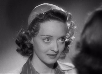 Movie still from “Dark Victory” (1939), directed by Edmund Goulding – An old photo of a woman with a hat on; Close Up shot, Over the shoulder angle