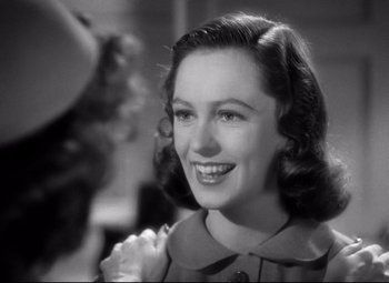 Movie still from “Dark Victory” (1939), directed by Edmund Goulding – An old black and white photo of a woman smiling; Close Up shot, Over the shoulder angle