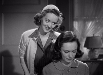 Movie still from “Dark Victory” (1939), directed by Edmund Goulding – Two women standing next to each other in front of a window; Medium shot, Over the shoulder angle