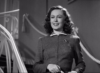 Movie still from “Dark Victory” (1939), directed by Edmund Goulding – A black and white photo of a woman smiling; Medium shot, Low angle