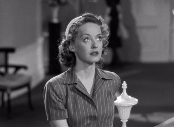 Movie still from “Dark Victory” (1939), directed by Edmund Goulding – A black - and - white photo of a woman in a striped shirt; Close Up shot, High angle