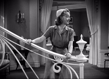 Movie still from “Dark Victory” (1939), directed by Edmund Goulding – An old photo of a woman standing on a balcony railing; Medium shot, High angle