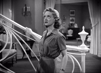 Movie still from “Dark Victory” (1939), directed by Edmund Goulding – An old photo of a woman standing in a living room; Medium shot, Low angle