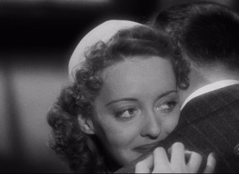 Movie still from “Dark Victory” (1939), directed by Edmund Goulding – An old black and white photo of a woman and a man; Close Up shot, High angle