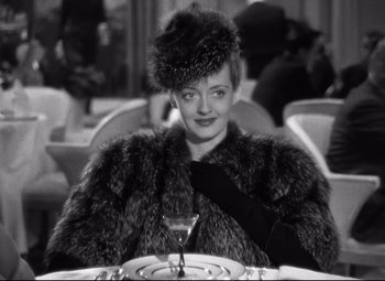 Movie still from “Dark Victory” (1939), directed by Edmund Goulding – A black and white photo of a woman in a fur coat; Close Up shot, High angle