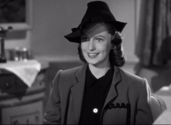 Movie still from “Dark Victory” (1939), directed by Edmund Goulding – A black and white photo of a woman wearing a hat; Medium shot, Over the shoulder angle