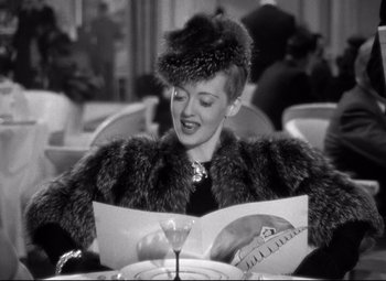 Movie still from “Dark Victory” (1939), directed by Edmund Goulding – A woman sitting at a table with a glass of wine; Close Up shot, Low angle