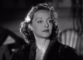 Movie still from “Dark Victory” (1939), directed by Edmund Goulding – An old photo of a woman in a fur coat looking to her left; Close Up shot, Low angle