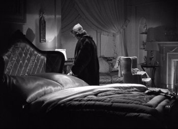 Movie still from “Dark Victory” (1939), directed by Edmund Goulding – An older man standing in a bedroom next to a bed; Wide shot, High angle