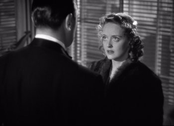 Movie still from “Dark Victory” (1939), directed by Edmund Goulding – An old photo of a man and a woman looking at each other; Close Up shot, Over the shoulder angle