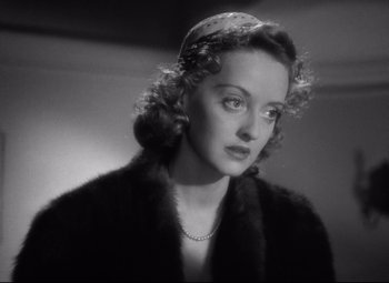 Movie still from “Dark Victory” (1939), directed by Edmund Goulding – An old photo of a woman in a fur coat; Close Up shot, Over the shoulder angle