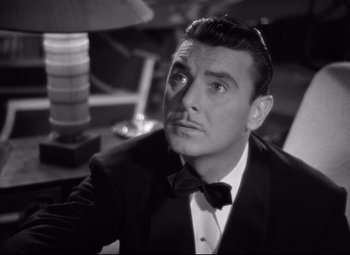 Movie still from “Dark Victory” (1939), directed by Edmund Goulding – A man in a suit and bow tie looking to his left; Close Up shot, Low angle