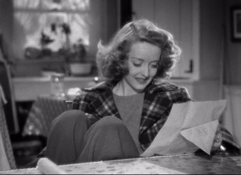 Movie still from “Dark Victory” (1939), directed by Edmund Goulding – A black and white photo of a woman looking at a piece of paper; Medium shot, High angle