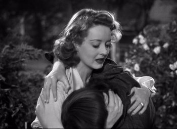 Movie still from “Dark Victory” (1939), directed by Edmund Goulding – A woman hugging another woman in a black and white photo; Close Up shot, High angle