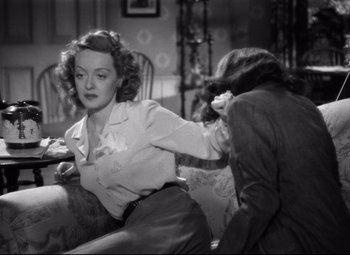 Movie still from “Dark Victory” (1939), directed by Edmund Goulding – A woman sitting on a couch next to another woman; Medium shot, High angle