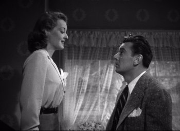 Movie still from “Dark Victory” (1939), directed by Edmund Goulding – A man and a woman standing next to each other in front of a window; Medium shot, Low angle