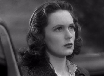 Movie still from “Dark Victory” (1939), directed by Edmund Goulding – An old photo of a beautiful woman with long dark hair; Close Up shot, Low angle