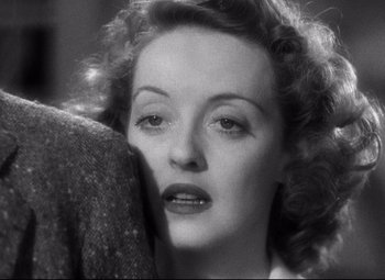 Movie still from “Dark Victory” (1939), directed by Edmund Goulding – An old photo of a woman looking at the camera; Close Up shot, Over the shoulder angle