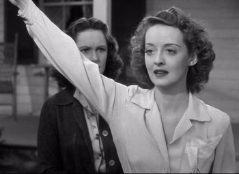 Movie still from “Dark Victory” (1939), directed by Edmund Goulding – A woman waves at the camera while another woman looks on; Medium shot, Low angle
