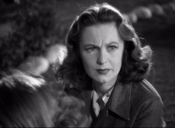 Movie still from “Dark Victory” (1939), directed by Edmund Goulding – An old photo of an older woman with long dark hair; Close Up shot, Over the shoulder angle