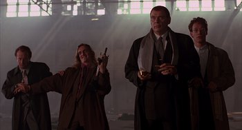 Movie still from “Darkman” (1990), directed by Sam Raimi – A man and a woman standing next to each other; Medium shot, Low angle