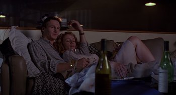 Movie still from “Darkman” (1990), directed by Sam Raimi – A man and a woman sitting next to each other on a couch; Medium shot, High angle